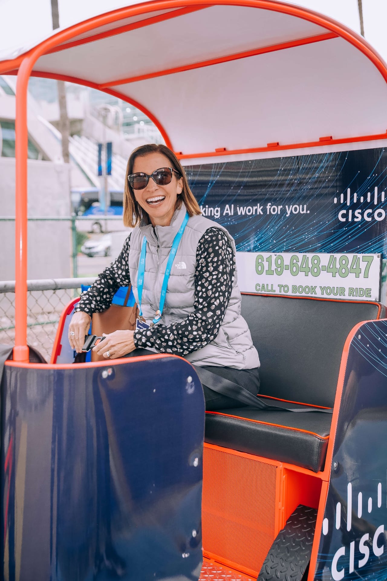 Happy passenger in Cisco branded pedicab at San Diego convention