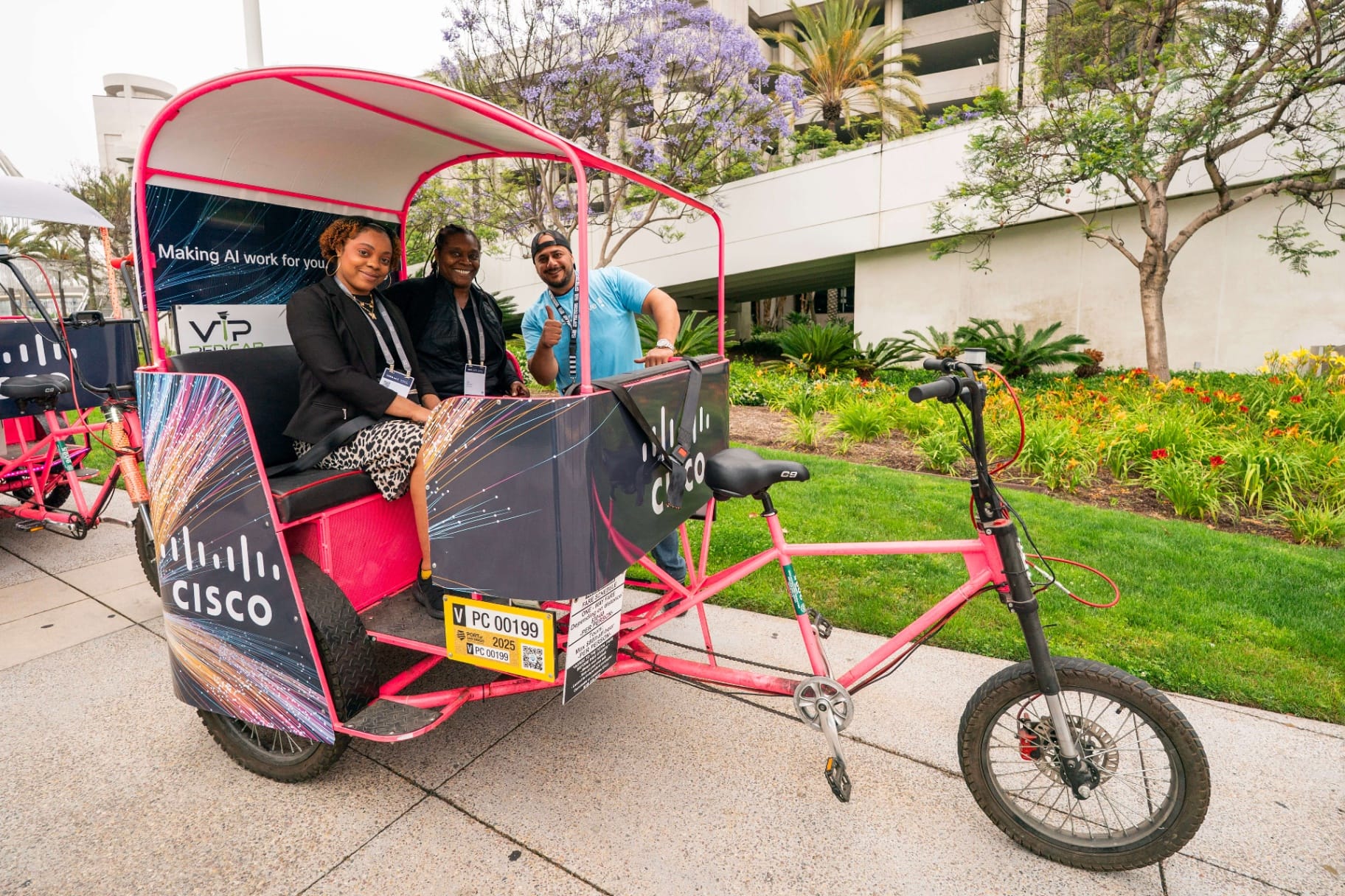 Happy Cisco pedicab passengers with driver at Hilton San Diego