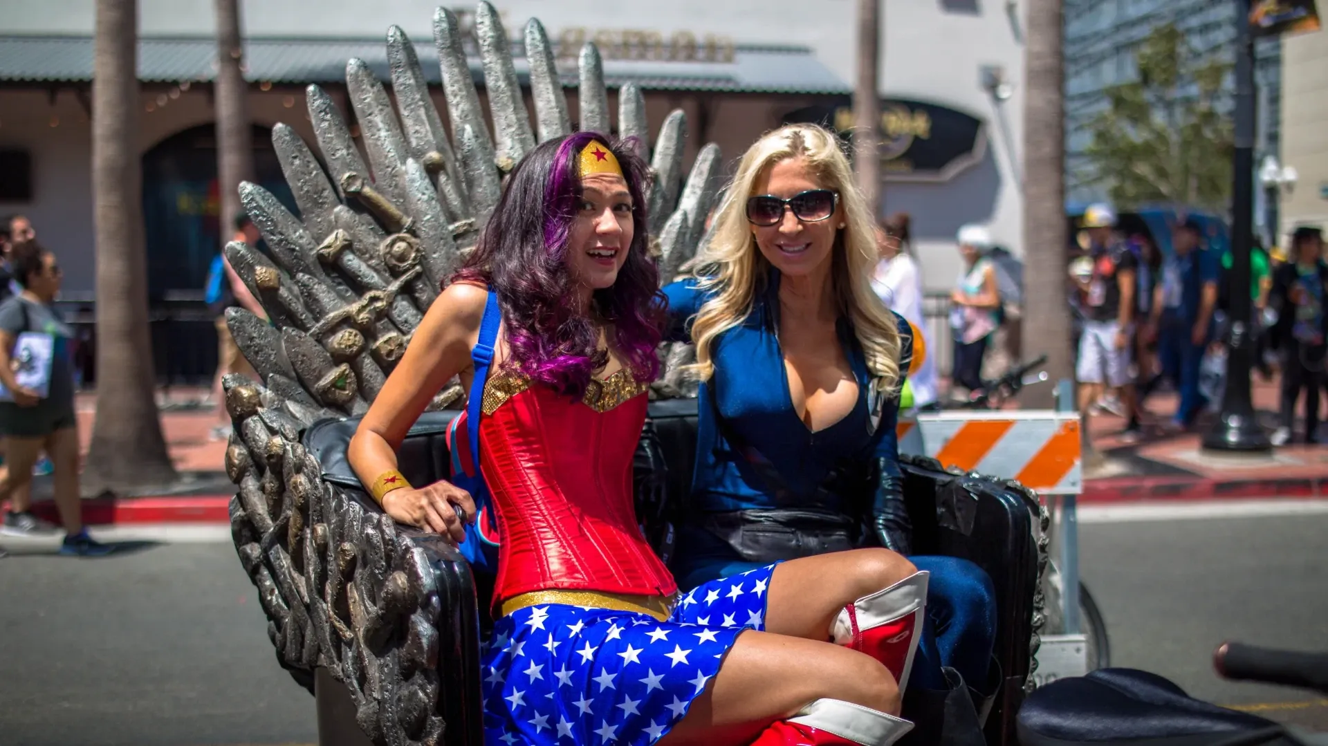 Cosplayers in Wonder Woman costume riding Iron Throne pedicab at Comic-Con