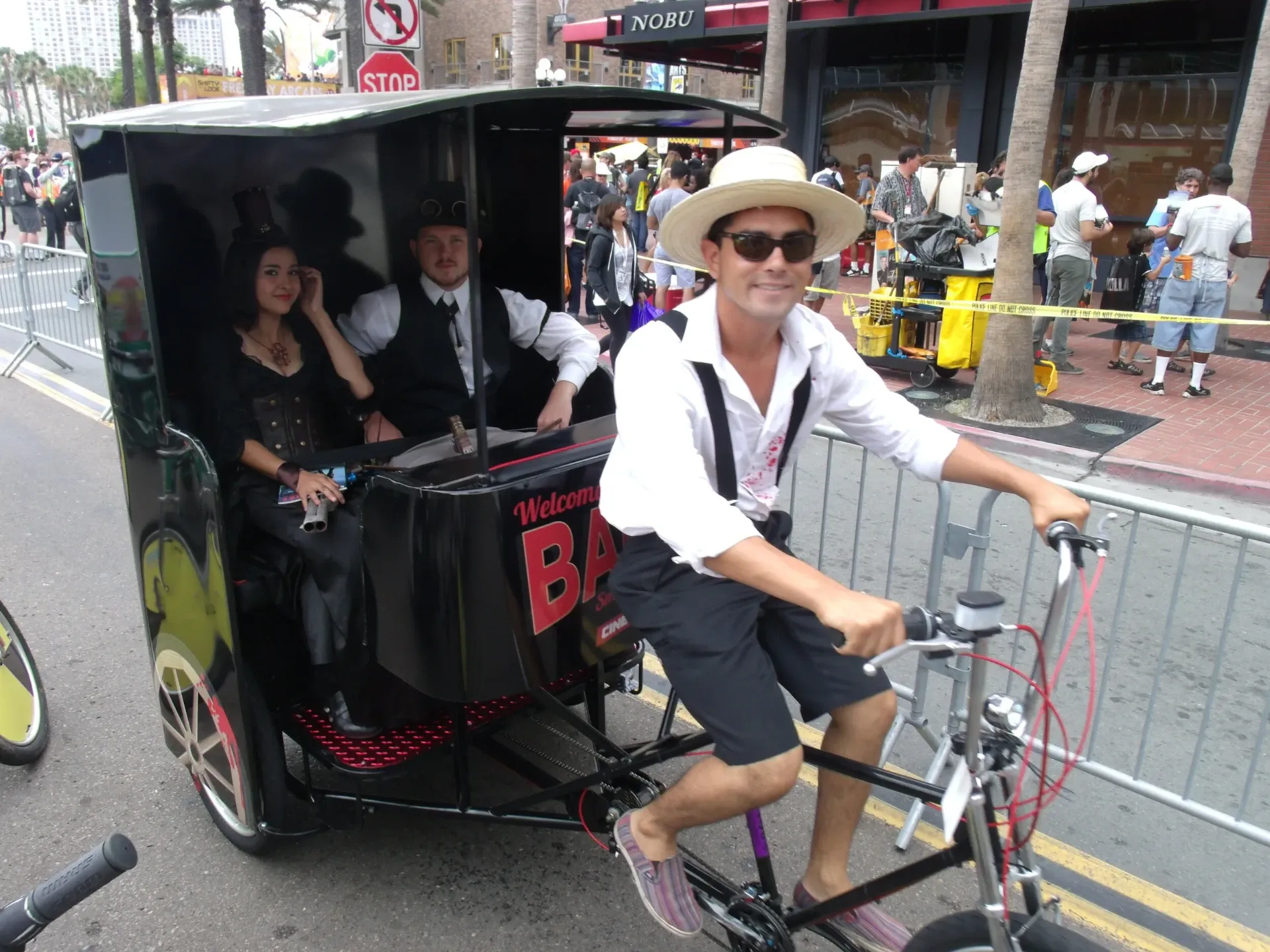 Pedicab driver with cosplay passengers in Gaslamp Quarter at Comic-Con
