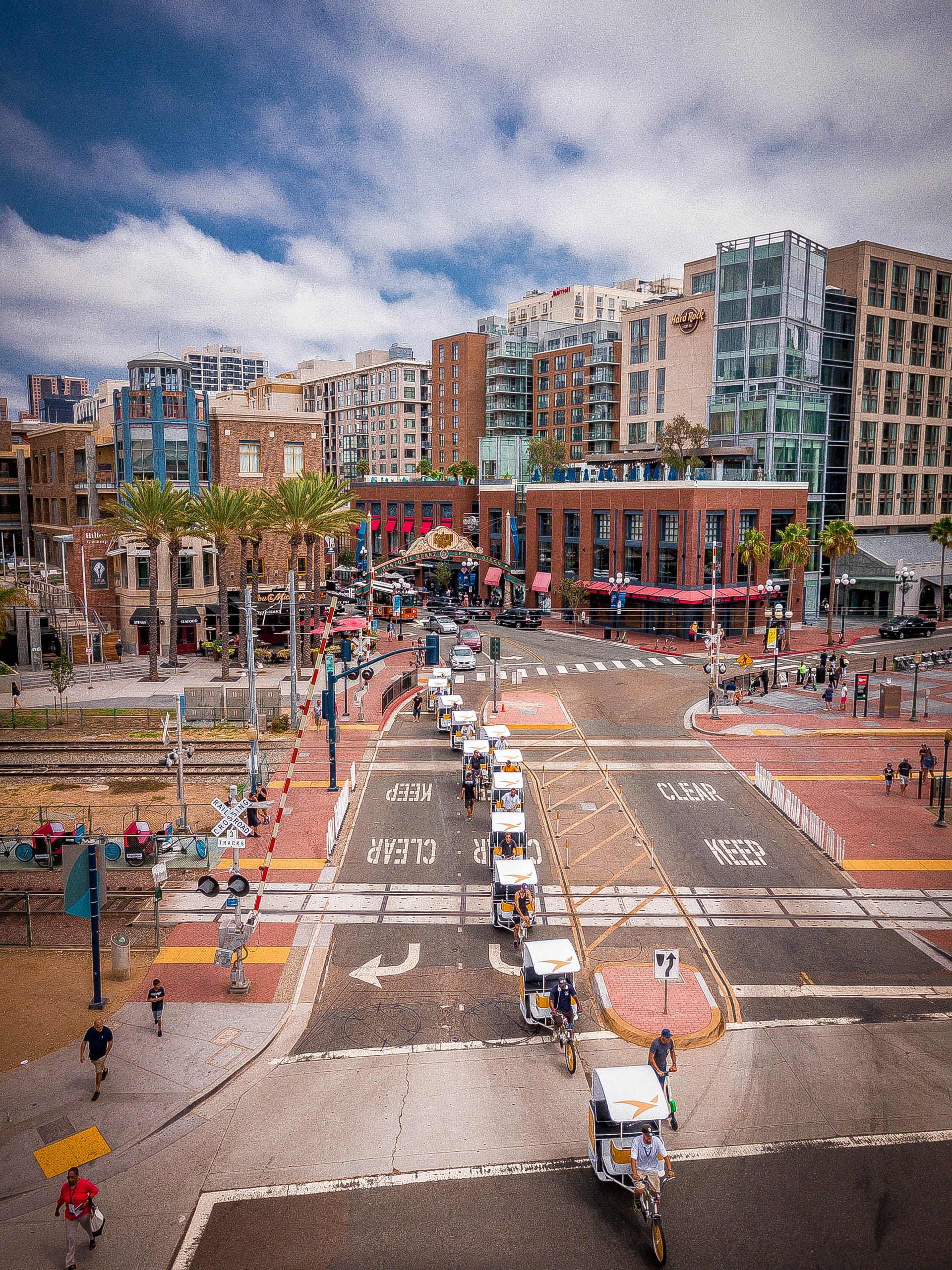 Branded pedicab fleet crossing the trolley tracks in San Diego's Gaslamp Quarter
