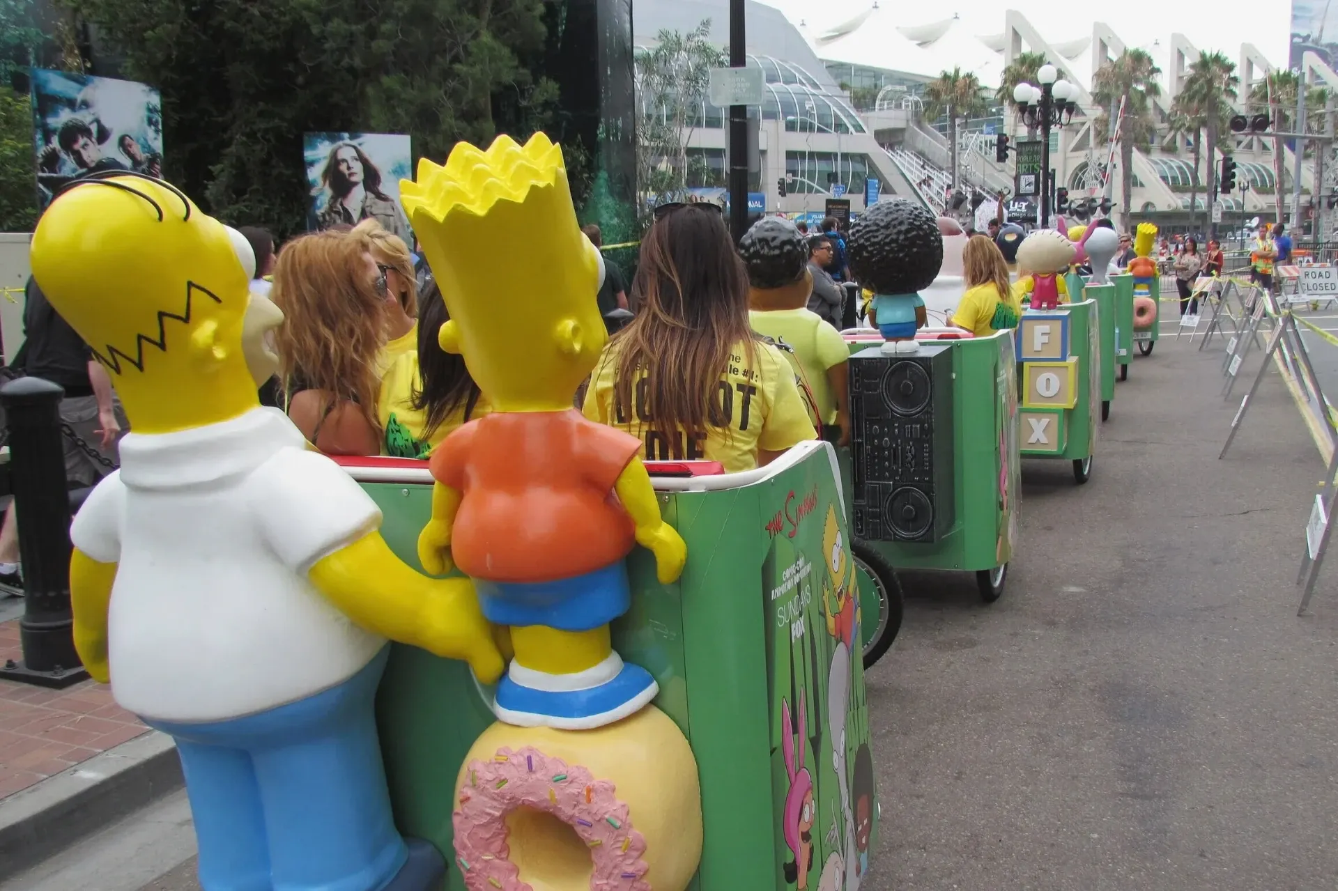 Simpsons FOX branded pedicab fleet with character statues at convention center Comic-Con