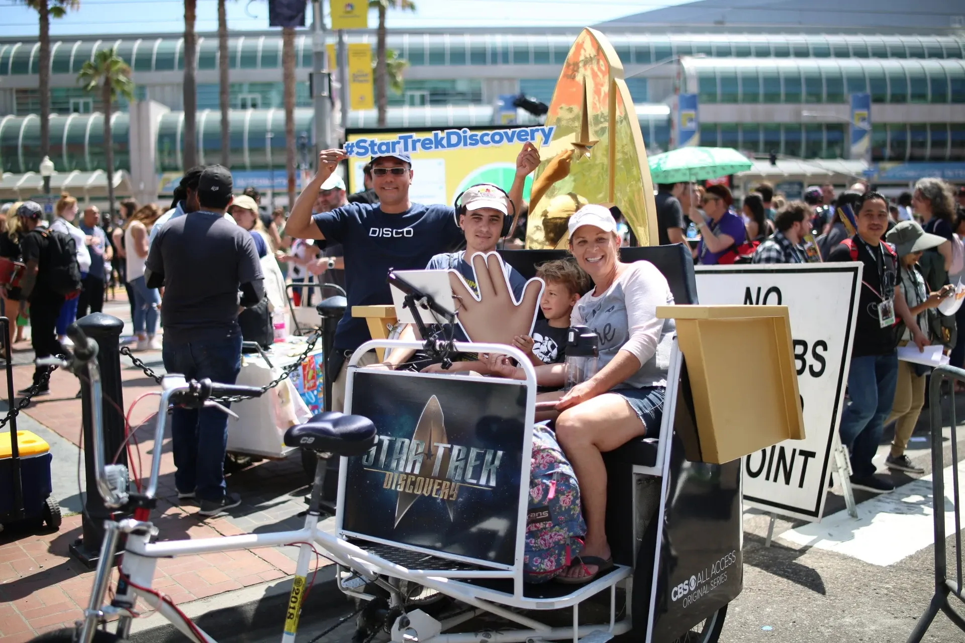 Family riding Star Trek Discovery branded pedicab at Comic-Con San Diego