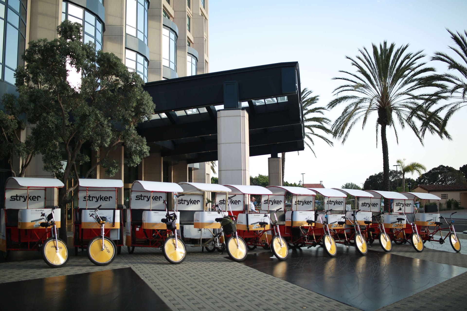 Stryker branded pedicab fleet lined up outside a San Diego hotel