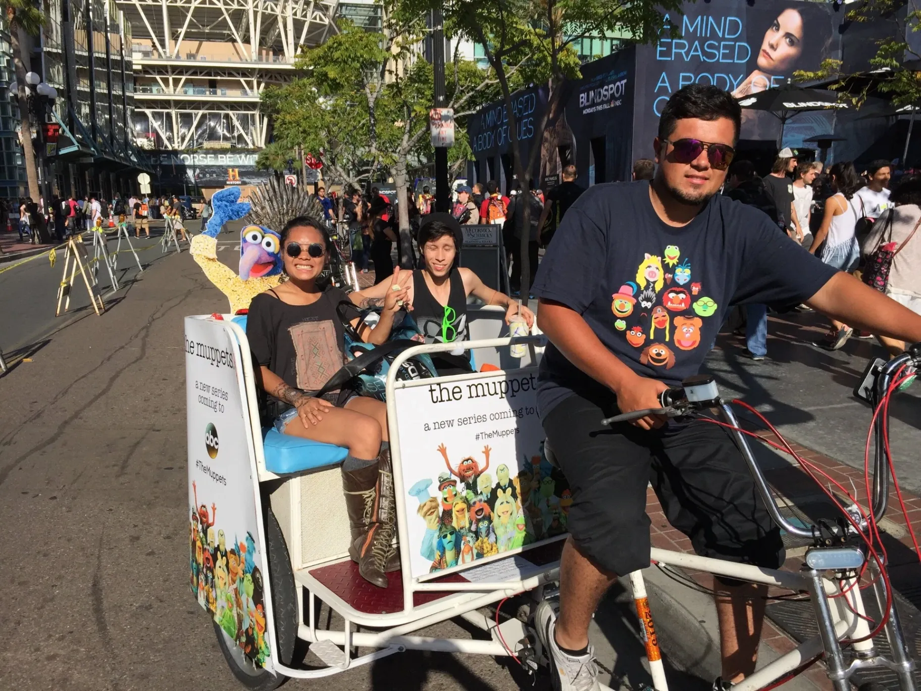 The Muppets ABC pedicab driver with Gonzo statue and passengers at Comic-Con