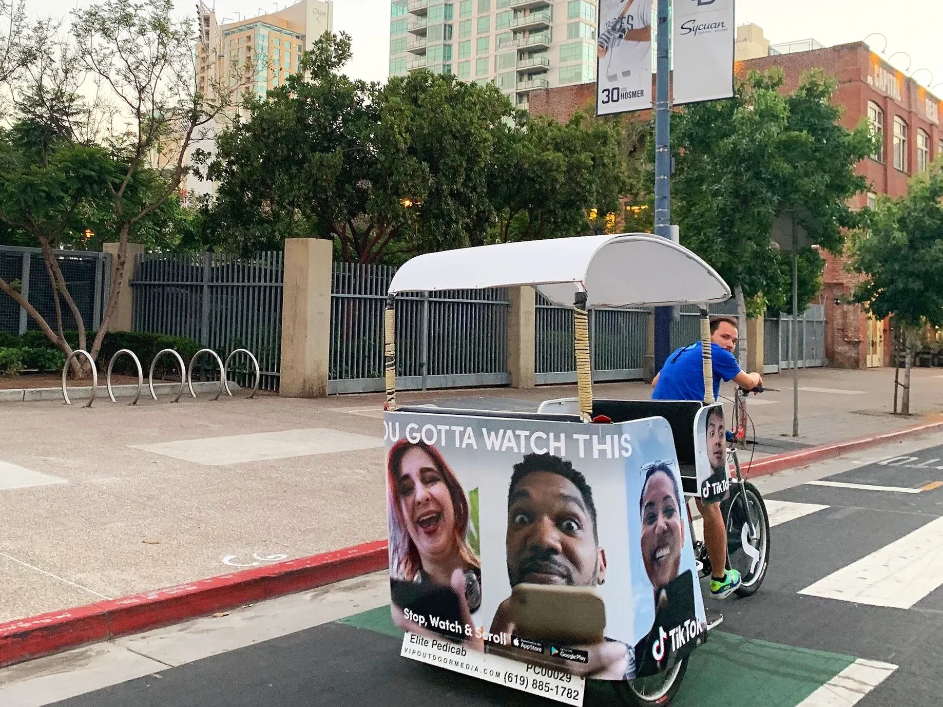 TikTok branded pedicab wrap with driver in downtown San Diego Comic-Con