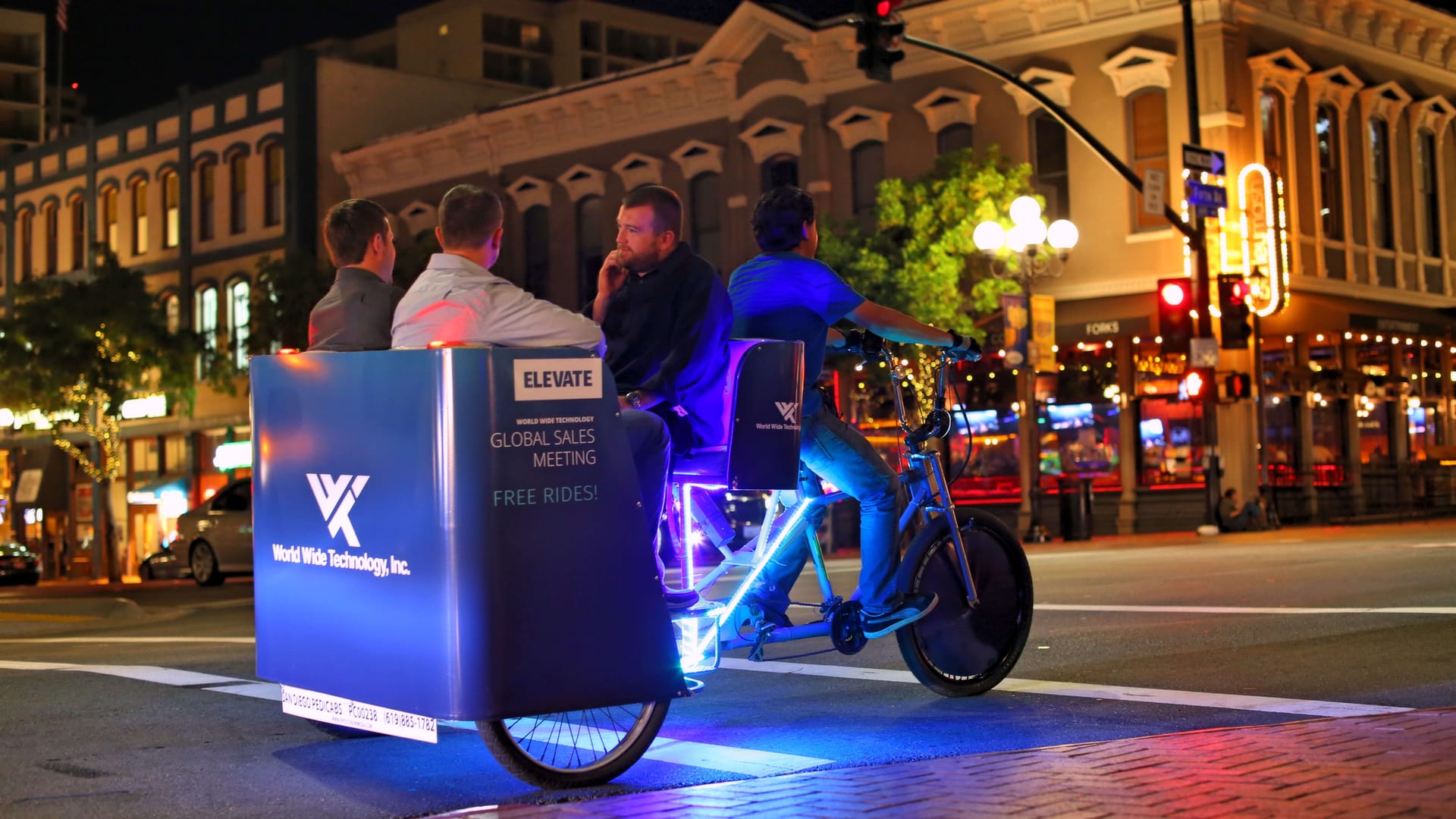 World Wide Technology branded LED pedicab at night in the Gaslamp Quarter San Diego